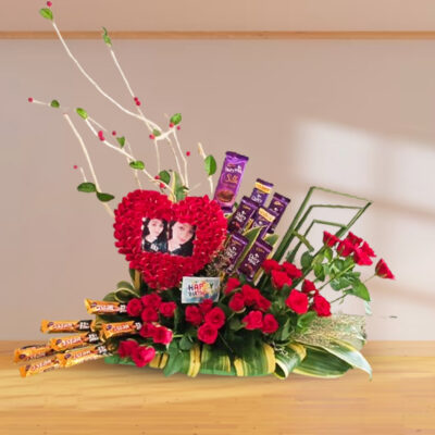 bouquet of red roses and chocolates and photo frame