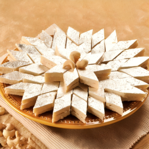 A 500g box of Kaju Katli, a classic Indian sweet made from cashews, known for its rich and melt-in-the-mouth texture.