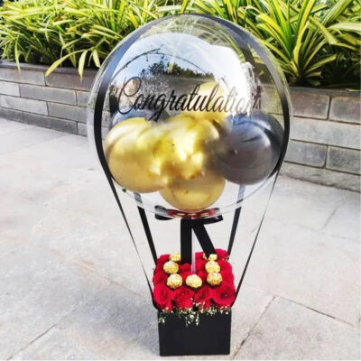 balloon bouquet tied to red rises and ferrero rocher chocolates in a black box