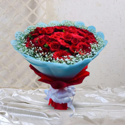A stunning bouquet featuring 30 Red Roses accented with white gypsum fillers, wrapped in sky blue and red paper and tied with a white ribbon.