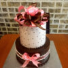 2 kg Cream Cake featuring a delectable blend of Vanilla and Chocolate Truffle flavors. This round-shaped masterpiece is elegantly adorned with ribbons for a touch of sophistication.