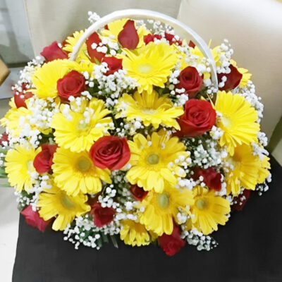 our enchanting floral arrangement. Featuring 30 radiant red roses and 30 cheerful yellow gerbera daisies, complemented by delicate gypsy fillers, this bouquet is a stunning celebration of color and elegance.