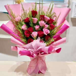 A delightful arrangement featuring 10 red roses, 10 pink roses, and adorned with fresh green murraya leaves.