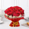 A lavish arrangement featuring 100 Red Roses, 40 White Gerberas, and lush green filler, elegantly presented in red jute packing paper with a golden ribbon bow.