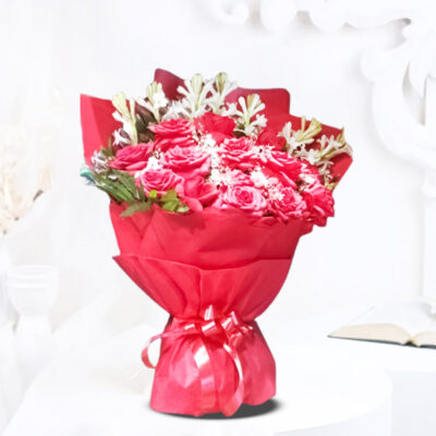 A charming bouquet featuring 12 Red Roses and 8 Tube Roses, wrapped in red non-woven packing paper and adorned with a red ribbon bow.