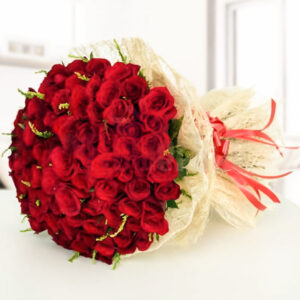 our exquisite bouquet of 75 red roses. Adorned with luxurious golden filler and elegantly wrapped in cream jute packing paper, this arrangement exudes timeless elegance and sophistication.